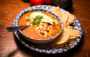 Close-up of flavorful Mexican chicken soup in a white bowl Close-up of flavorful Mexican chicken soup in a white bowl